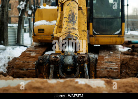 arm and bucket cylinder of old excavator in winter outdoor, close-up Stock Photo