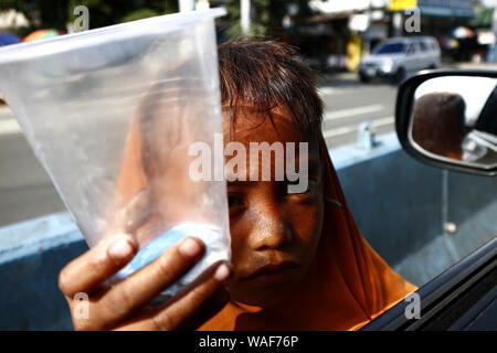 CAINTA, RIZAL, PHILIPPINES – AUGUST 18, 2019: Customers of an ice cream store enjoy ice cream and other cold snack items. Stock Photo