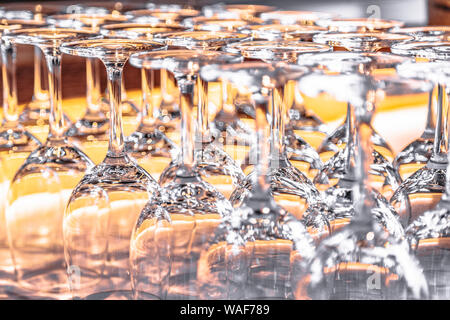 Many upturned wine glasses on table close up Stock Photo