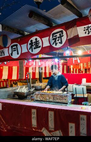 Cherry blossom festival, Hanami, Japanese at a food stall, Hirano shrine, Kyoto, Japan Stock Photo