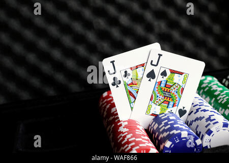 Pair of jacks playing cards upright on top of poker chips Stock Photo