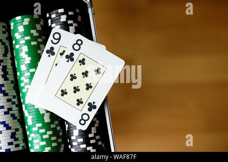 Two Playing Cards on top of Stacks of Poker Chips Stock Photo