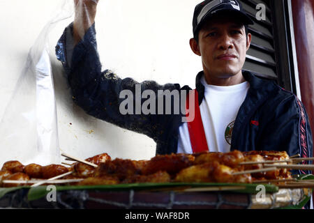 ANTIPOLO CITY, PHILIPPINES – AUGUST 16, 2019: Street vendor showing deep fried sweet snacks like Turon or sweet banana, Carioca or rice flour balls an Stock Photo