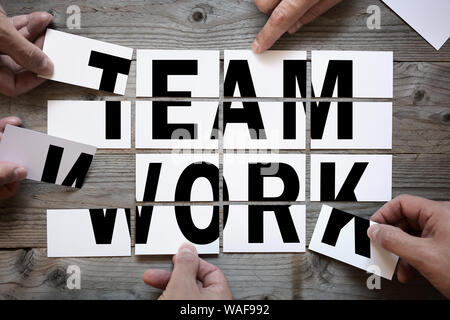 Business team brainstorming - teamwork or solution with word team work on cards Stock Photo