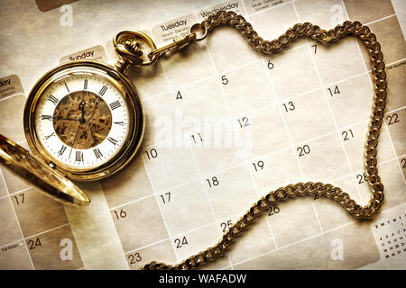 Time management, gold pocket watch on blank calendar background Stock Photo