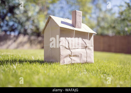 New house wrapped in brown paper concept for construction Stock Photo