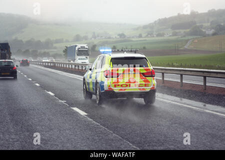 Police siren flashing blue lights driving on motorway to accident or crime scene Stock Photo