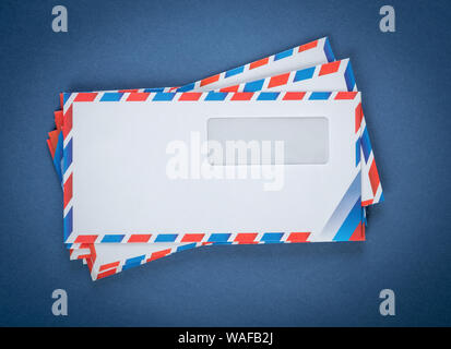 A stack of envelopes on a blue background Stock Photo