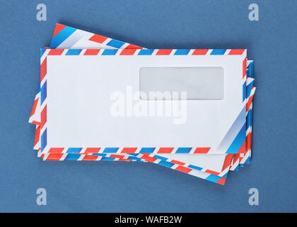 A stack of envelopes on a blue background Stock Photo