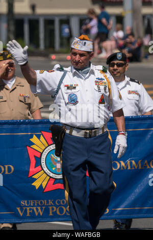 Long Island, NY - Circa 2019: United States veterans march in Memorial Day parade celebration to honor military men and women who have served country Stock Photo