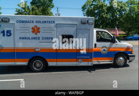 Long Island, NY - Circa 2019: Local volunteer ambulance rushing to emergency down busy suburban road to provide medical assistance and help Stock Photo