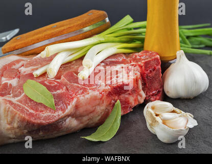 Piece of pork meat on the black stone table Stock Photo