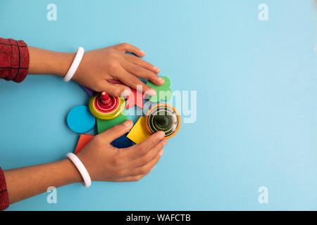 Top view Colorful Wooden building blocks with different shapes for developing and entertainment of Children on blue background Stock Photo