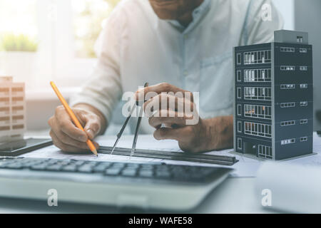 architect drawing new apartment building project in office Stock Photo