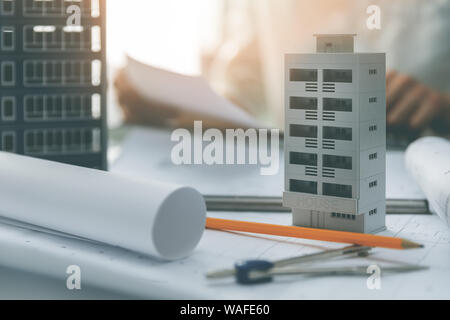 apartment building scale models and blueprints on the table in architect office Stock Photo