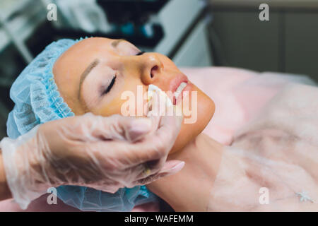 Close up of a hands threading beautiful womans upper lip. Stock Photo