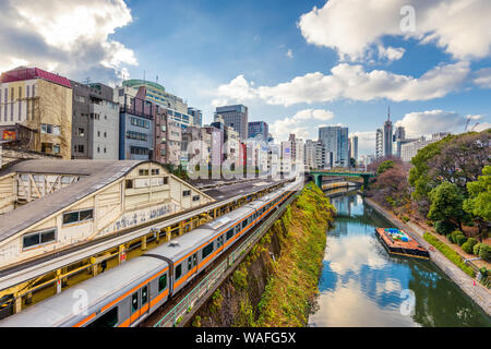 Trains pass by the Kanda River in the Ochanomizu district of Tokyo, Japan.