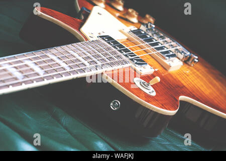 Elegant LP shape electric guitar, vintage look. Shallow depth of field. Stock Photo