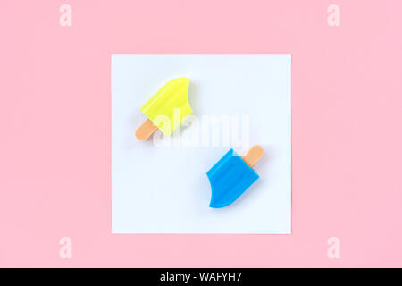 Blue and yellow ice cream in a white square on a pastel pink background Stock Photo