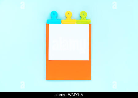 A white sheet for writing on an orange notebook  Stock Photo