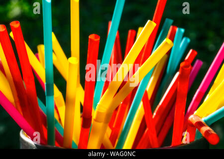 Many different colored straws against a dark background Stock Photo