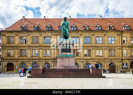 Stuttgart, Germany, August 15, 2019, Cobblestone square schillerplatz with statue of famous german poet friedrich schiller as memorial monument with m Stock Photo