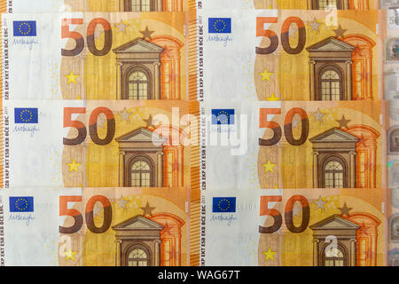 Banknotes 50 euros beautifully laid out. Euro notes background on a long banner. Beautiful original cash flow. Stock Photo