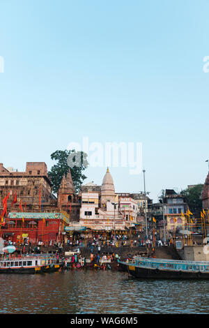 Boats with tourists on water of Ganges River close to Ghat at sunsrise Stock Photo