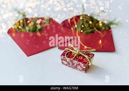 Two red envelopes with fir branches. New Year's gift. Selective focus. Stock Photo