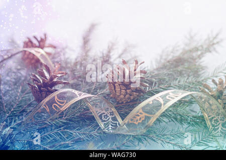 Fir branches and cones, gift ribbon. Christmas and New Year background. Stock Photo