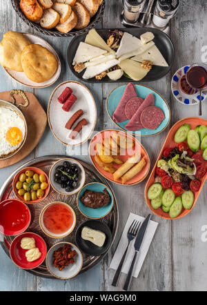 Traditional Turkish Breakfast served with traditional turkish tea on wooden table Stock Photo