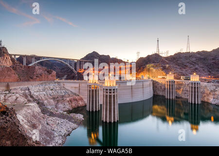 Hooover Dam on the Colorado River straddling Nevada and Arizona at dusk. Stock Photo