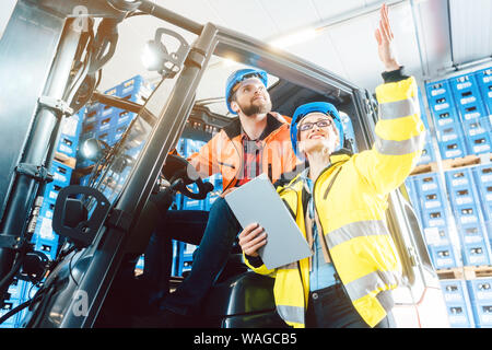 Workers in logistics warehouse checking the inventory Stock Photo