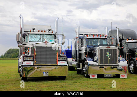 Alaharma, Finland. August 9, 2019. Classic American Kenworth W900B and Peterbilt 359 big rigs with shiny chrome lined up on Power Truck Show 2019. Stock Photo