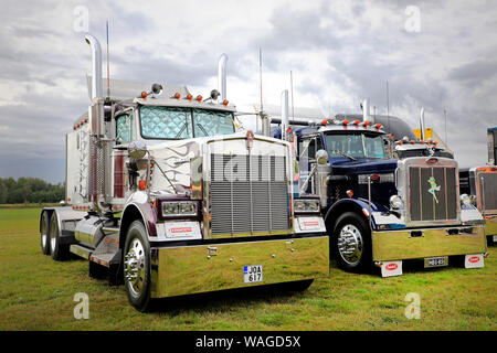 Alaharma, Finland. August 9, 2019. Classic American Kenworth W900B and Peterbilt 359 big rigs with shiny chrome lined up on Power Truck Show 2019. Stock Photo