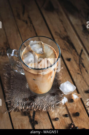 Ice coffee in a glass on wooden background Stock Photo