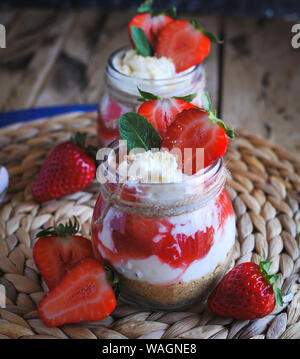 Close-up of homemade strawberry cheesecake in a jar