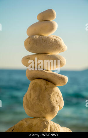 White Stone stacked together on blue background. Relax and balance. Stock Photo