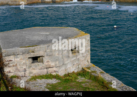 War World II pill box FW3/24 at the entrance to Porthleven Harbour, Porthleven, Cornwall, England, UK Stock Photo