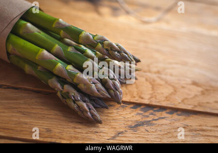 Close-up of fresh green asparagus on wooden background Stock Photo