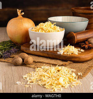 Dry Kibbled Onions in a bowl and food preparation and kitchen setting Stock Photo