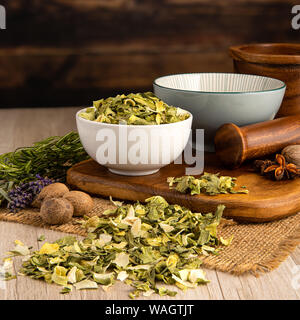Leek Flakes in a bowl and food preparation and kitchen setting Stock Photo
