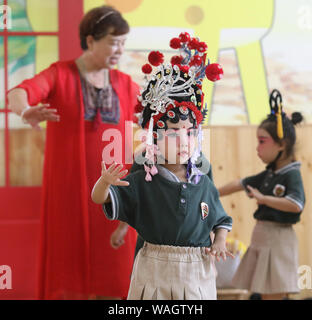 Shijiazhuang, China's Hebei Province. 20th Aug, 2019. Kids practice the Weishui Sixian under the instructions of an actress in a kindergarten in Jingxing County of Shijiazhuang City, capital of north China's Hebei Province, Aug. 20, 2019. Sixian is a local opera in Hebei as well as a provincial intangible cultural heritage. Credit: Zhao Danhui/Xinhua/Alamy Live News Stock Photo