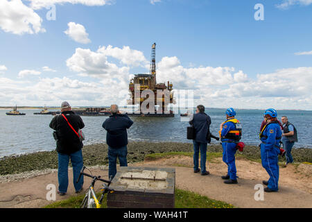 After over 40 years of oil production, the decommissioned Brent Bravo oil rig is towed into the River Tees estuary to be broken up for scrap. Stock Photo