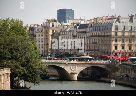 Paris, France - July 07, 2018: Pont Neuf Bridge with lots of people walking and art deco building in the background Stock Photo