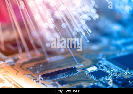 Closeup on electronic board and neon electric lights, blurred and toned electronic background in pink, blue and purple Stock Photo