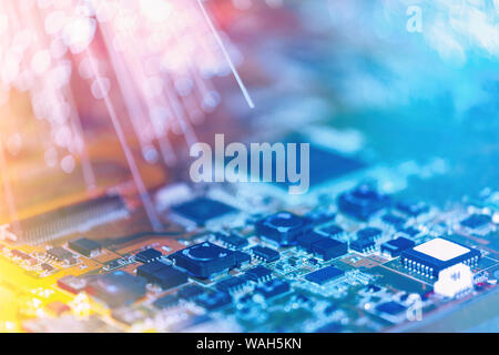 Closeup on electronic board and neon electric lights, blurred and toned electronic background in pink, blue and purple Stock Photo