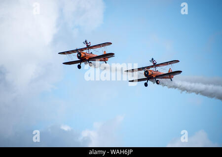 Aerobatic Formation Wing walking display by Aerosuperbatics team formerly the Breitling Wingwalkers, Crunchie Flying Circus and Utterly Butterfly team Stock Photo