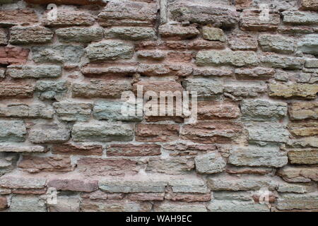 Destroyed by time and precipitation brick wall. The Background of old vintage brick wall Stock Photo
