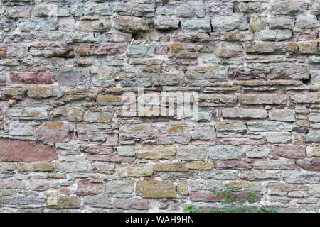 Destroyed by time and precipitation brick wall. The Background of old vintage brick wall Stock Photo